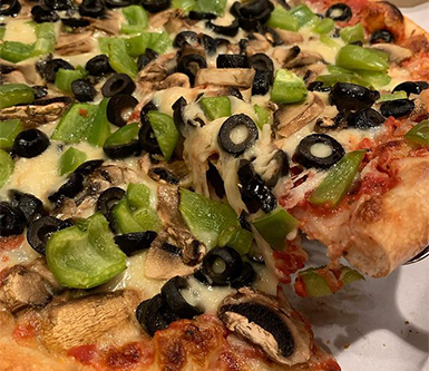 Peppers, mushrooms, and black olive pizza